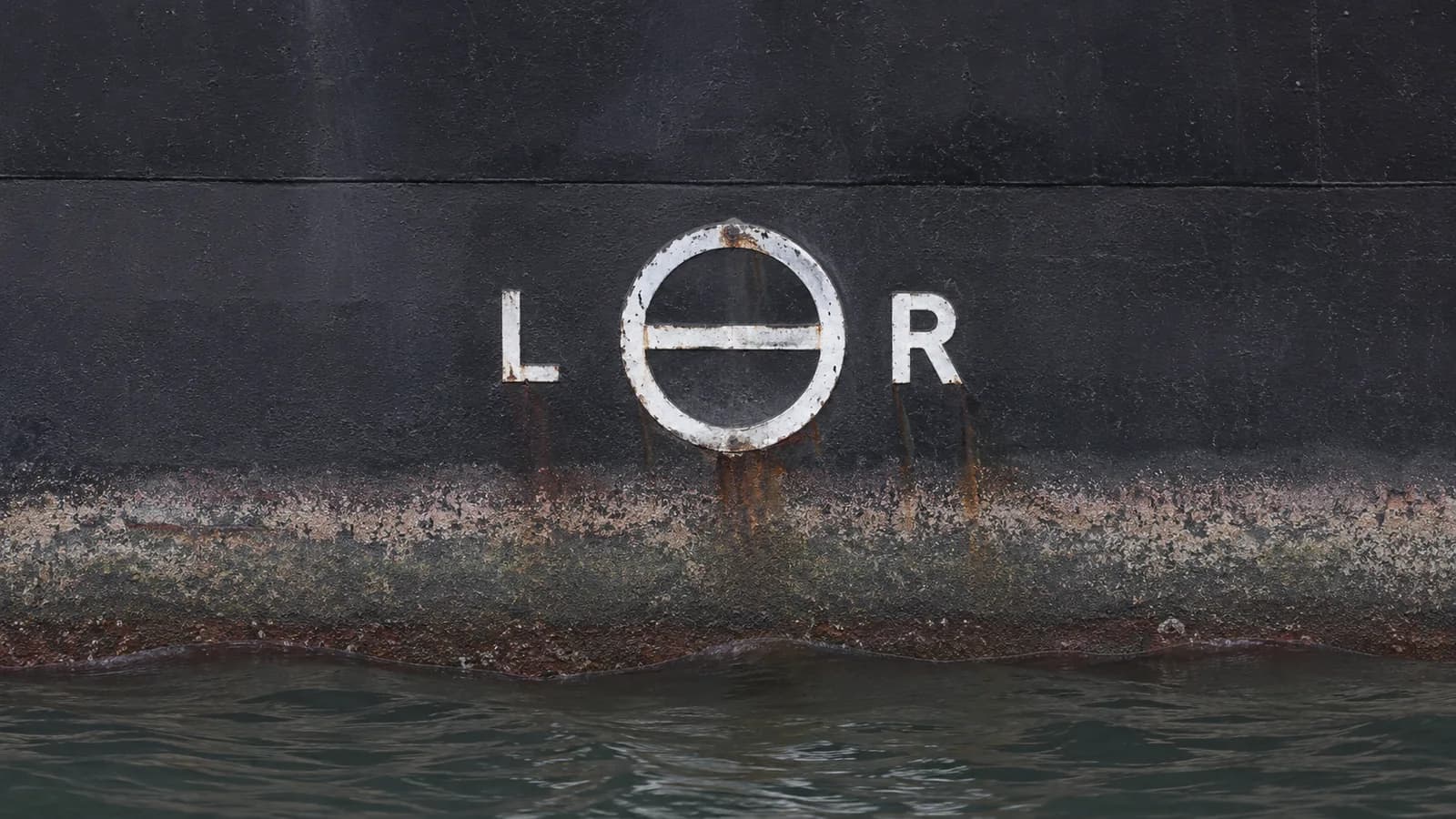 Load line disc welded to the side of a ship's hull above the waterline
